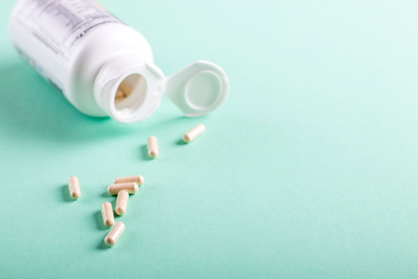 A picture of supplements on top of a turquoise background